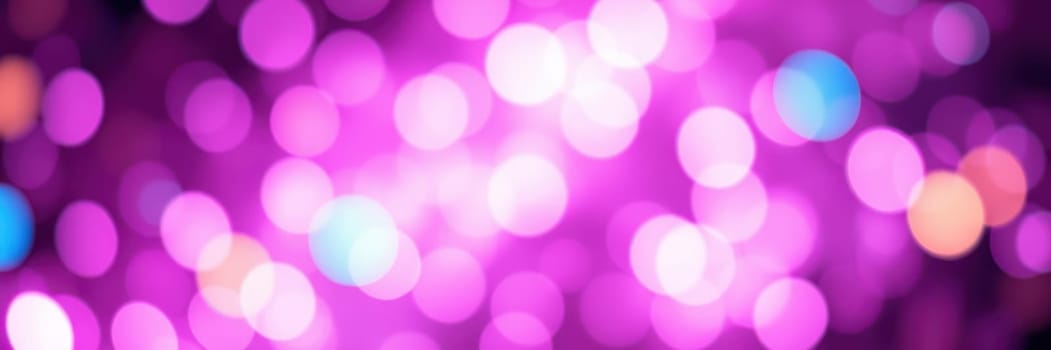 Bright purple bokeh lights illuminate the area during an evening event in the city park, creating a festive and lively atmosphere for attendees enjoying the celebration.