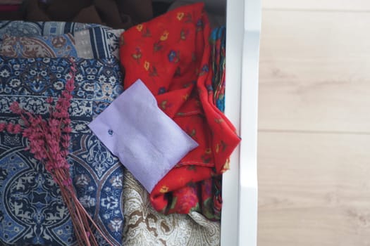 A vibrant collection of beautiful fabrics and a charming note in a stylish drawer adds elegance