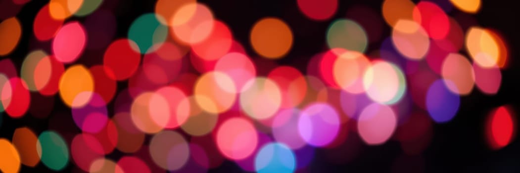 Vibrant, colorful lights fill the background, creating a joyful ambiance perfect for a nighttime celebration as day transitions into night.
