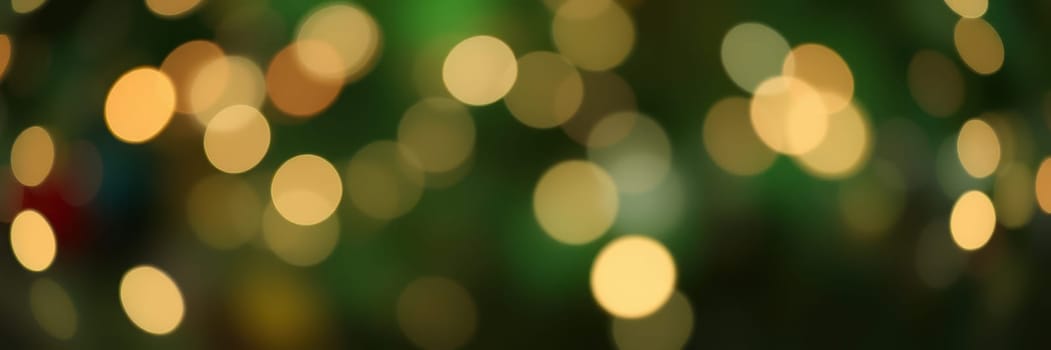 Bright, circular lights out of focus create a magical atmosphere, perfect for holiday celebrations. The vibrant colors enhance the festive mood and joy of the season.