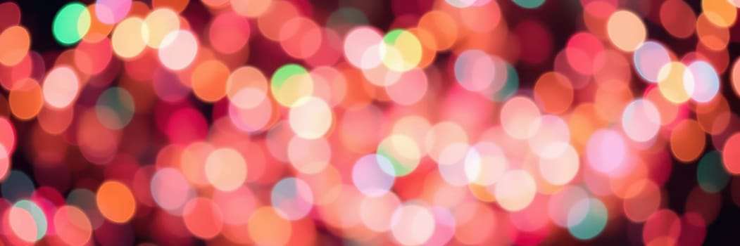 Bright and colorful bokeh lights fill the background, creating a festive atmosphere against a dark night sky. The vibrant hues enhance the joyous mood of the celebration.