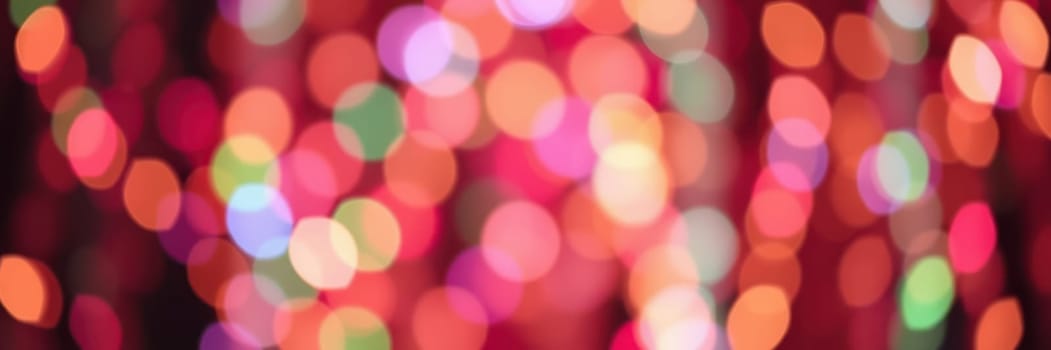 Brightly colored lights create a vibrant atmosphere during a celebration. The joyful gathering showcases people enjoying music, food, and each other's company in a lively setting.