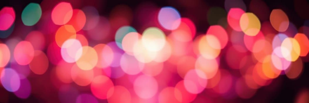 A series of blurred, colorful lights shines brightly, creating a lively atmosphere in a city at night. This display evokes feelings of celebration and joy.