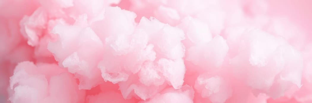 Fluffy pink cotton candy puffs fill the air, creating a dreamy and playful atmosphere at a summer fair. Families enjoy the sweet treat while vibrant stalls attract visitors.