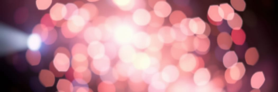 Bright, glowing bokeh lights create a vibrant atmosphere during a nighttime event in a city. The colors blend as night falls, enhancing the festive mood and excitement.