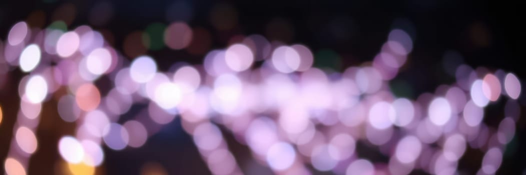 Bright and colorful string lights adorn the setting, creating a lively ambiance during an outdoor event in the city at night, filled with joy and celebration.