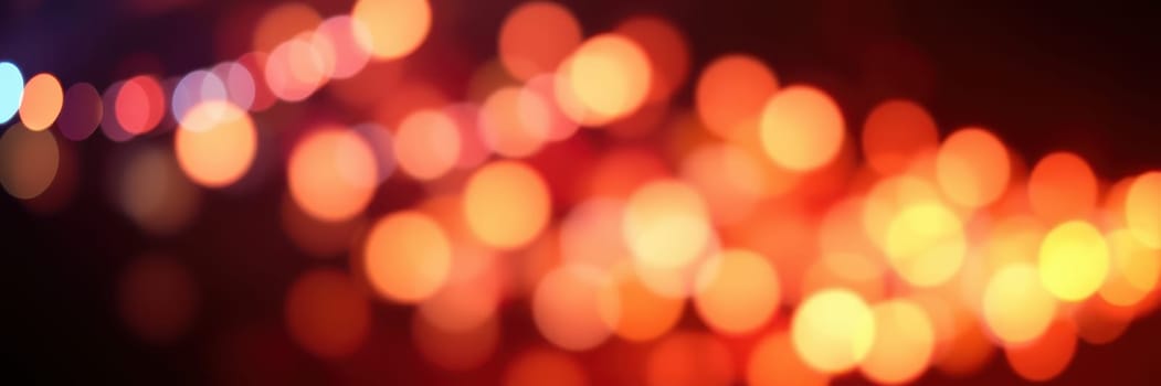 Soft, blurred lights illuminate the darkness, creating a magical ambiance. The warm hues enhance the energy of a vibrant nighttime celebration in the city.