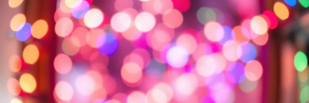 Shimmering bokeh lights fill the background with cheerful colors, enhancing the festive atmosphere of an indoor space during the holiday season, inviting joy and celebration.