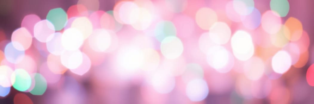 Bright bokeh lights illuminate the evening sky at a local festival, creating a lively, enchanting atmosphere. People enjoy the festivities and celebrate together in joy.