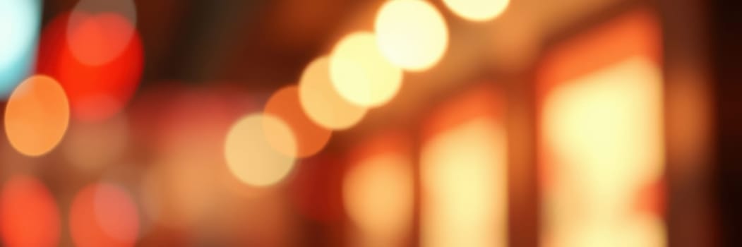 Colorful bokeh lights illuminate a street, enhancing the evening ambiance with a warm glow. The blurred effect creates a dreamlike quality, making the urban landscape inviting.