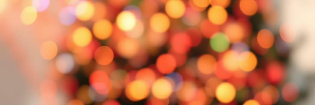 Soft, out-of-focus lights in vibrant hues fill the background, enhancing the warm ambiance of a home decorated for the holiday season, creating a feeling of joy and celebration.