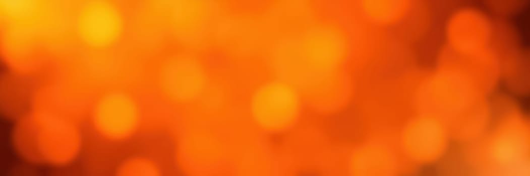 A warm glow of orange bokeh lights fills the backdrop of a lively evening gathering. The vibrant colors enhance the celebratory mood, inviting joy and excitement.