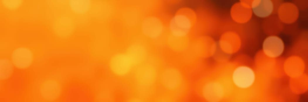 A warm display of blurred orange bokeh lights fills the background, offering a cozy ambiance ideal for autumn gatherings and celebrations in the evening.