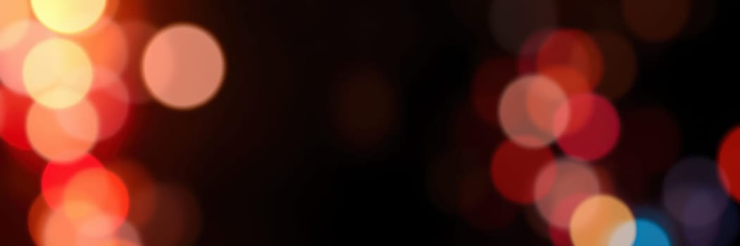 Vibrant bokeh lights in red, orange, and yellow fill the background, enhancing the warm, festive atmosphere ideal for gatherings during celebrations.