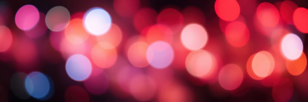 Vivid, multicolored lights blend together in a blurred display, capturing the lively spirit of a nighttime event filled with joy and excitement.