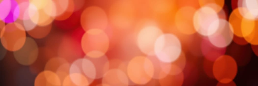 Colorful light patterns shimmer and blend together, creating a lively and energetic atmosphere during a nighttime celebration in an urban environment filled with excitement.