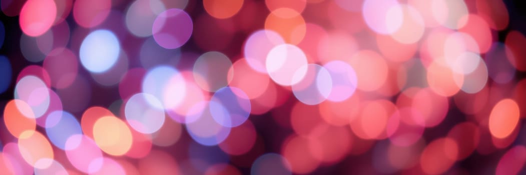 A mesmerizing display of colorful bokeh lights illuminates the night, enhancing the festive atmosphere and creating a lively ambiance in a bustling urban setting.