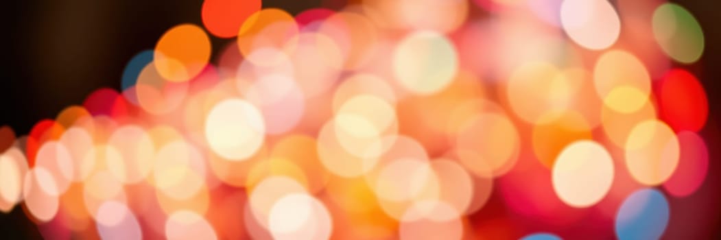 Brightly colored bokeh lights fill the background, creating a vibrant and cheerful ambiance for the evening gathering in a city setting. The atmosphere is lively and inviting.