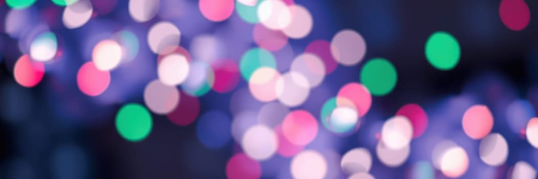 Bright, colorful bokeh lights enhance the festive atmosphere of a nighttime celebration, creating a joyful and vibrant setting, with vivid shades of pink, blue, and green.