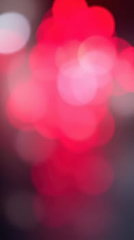 Rich red bokeh lights fill the space, evoking a warm, festive feeling. The soft glow enhances the nightlife ambiance as it blurs into the background, perfect for celebrations.