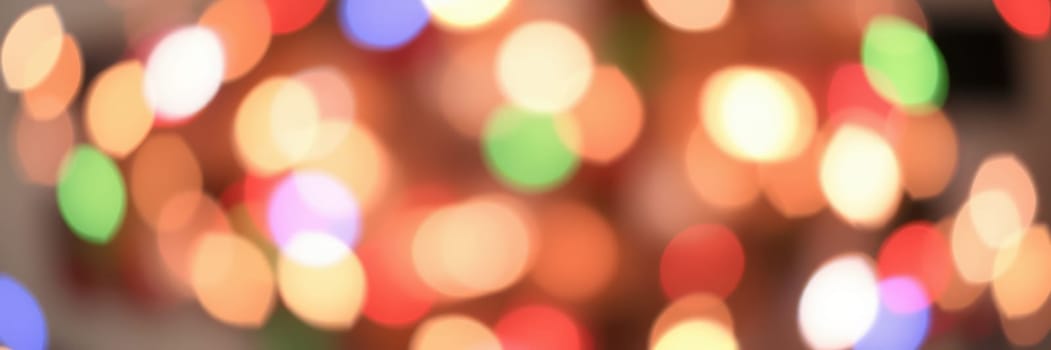 Bright, colorful lights blur together, creating a vibrant bokeh effect that enhances the festive mood of a celebration. The warm ambiance fills the night with joy.