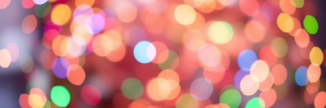 Vibrant bokeh lights in various colors fill the background, enhancing the joyful ambiance of a festive gathering during the holiday season at an event venue.