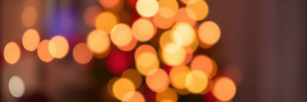 Colorful lights twinkle on a decorated tree, creating a warm and inviting ambiance in a home during a winter evening celebration filled with laughter and joy.