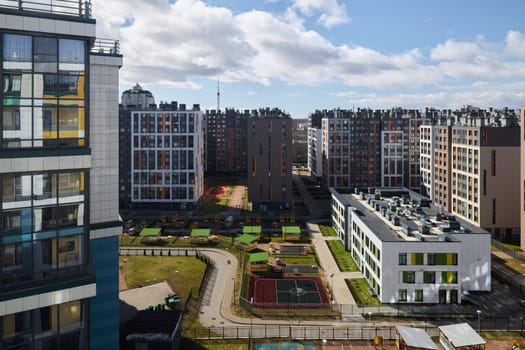 An aerial view showcasing a modern residential area filled with contemporary buildings and lush green spaces thriving