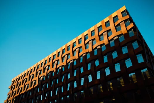 A breathtaking view showcasing a contemporary building that features a striking geometric design against a vibrant sky