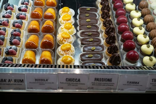 Cremona, Italy - November 27th 2024 Mouthwatering pastries. Including baba al rum. Chiche. And passione. Are beautifully arranged in a display case in cremona. Italy