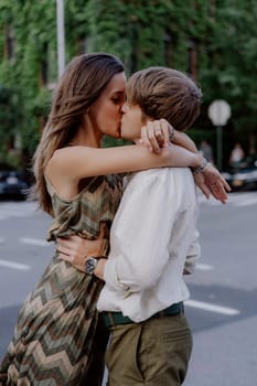 A romantic moment is captured between a couple in a vibrant urban setting filled with lush greenery