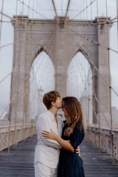A loving couple shares a romantic moment on the iconic Brooklyn Bridge, capturing their extraordinary bond