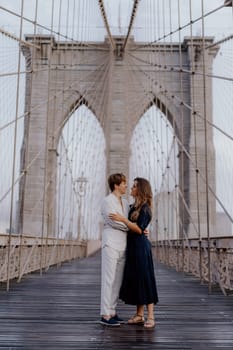 A loving couple shares a romantic moment on the iconic Brooklyn Bridge, capturing their extraordinary bond