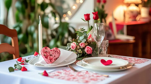 Festive table setting with candles and arrangement of beautiful red flowers. Holiday concept. High quality photo