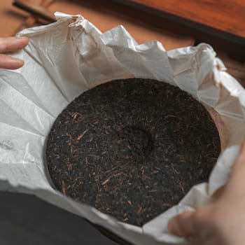 A closeup view of carefully wrapped tea leaves, showcasing the intricate art and tradition of tea storage