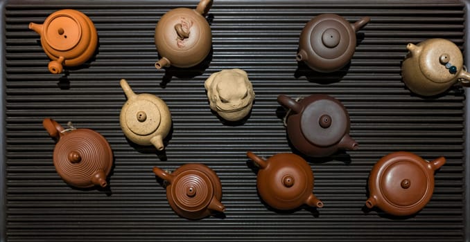 A breathtaking collection of intricately designed teapots that highlight a variety of colors on a sleek surface