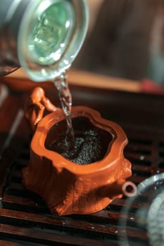 Discover the exquisite art of tea preparation with a delightful and graceful pour into a charming teapot