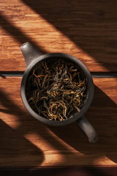 Dried tea leaves in a rustic pot capture natures essence and enhance our overall wellness experience