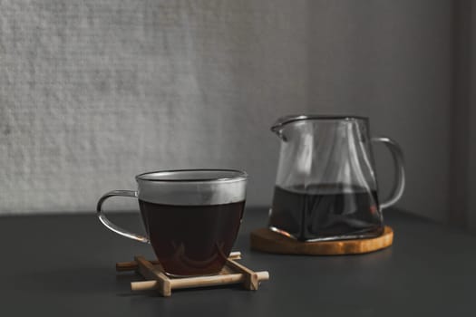 This chic photo features a coffee cup and a stylish pitcher, showcasing a warm and minimalist coffee experience