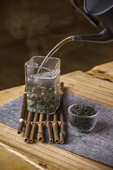 Expert tea preparation with elegant bamboo elements, showcasing the tranquil essence of tea culture