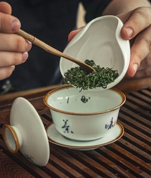 This is a detailed view of tea preparation, focusing on traditional Chinese teaware and loose leaf tea