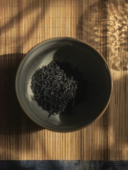 Aesthetically pleasing black rice in a bowl on a woodtextured surface, showcasing culinary simplicity and elegance