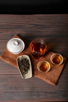 Immerse yourself in the exquisite art of tea with loose leaves, elegant cups, and a traditional pot for brewing