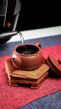 A Yixing teapot elegantly pours tea, showcasing the art of brewing in a cozy atmosphere for enjoyment and relaxation
