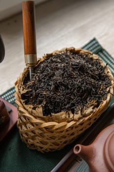 Aesthetic photo of beautifully crafted loose leaf black tea, elegantly displayed in a traditional basket