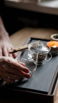 Enjoy a serene tea brewing moment with beautiful glassware and nature, perfect for relaxation and tranquility