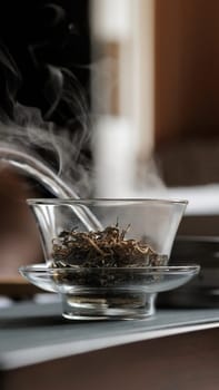 This image shows a closeup of steaming herbal tea in a glass teapot, highlighting its natural beauty and warmth
