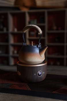 A beautifully crafted ceramic teapot elegantly resting on a stylish wooden base, perfect for all tea lovers