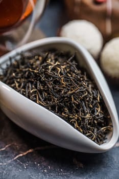 Luxurious and elegantly dry black tea leaves are beautifully displayed in a bowl, perfect for all tea enthusiasts