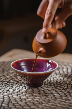 A beautifully captured scene of pouring tea gracefully into a bowl, showcasing the art of traditional tea ceremonies
